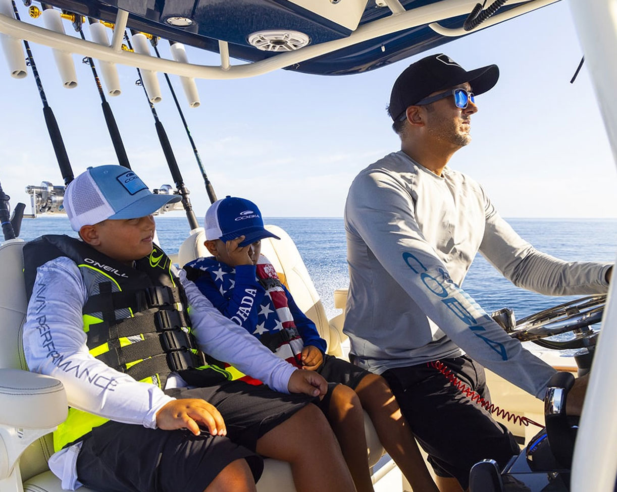 man and his sons on a boat